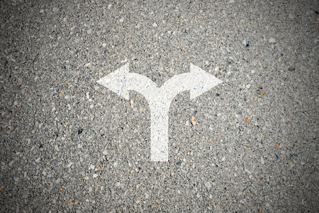 Crossroad sign on asphalt concrete street and two direction to make decision - left or rightの写真素材