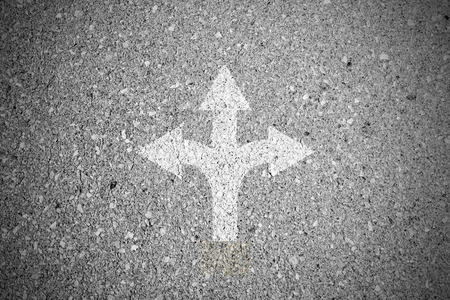 Crossroad sign on asphalt concrete street and three way to make a decisionの写真素材