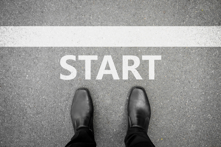 black shoes standing at the start line to start or begin new lifeの写真素材