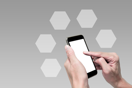 Hands using smartphone and blank hexagonal transparent box to fill data or choicesの写真素材