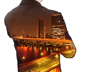 Isolated double exposure of businessman in suit and cityscape at night. He's looking for his success in business and idea for lifeのeditorial素材