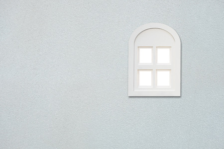 White window on white concrete wall. Minimal exterior design.の写真素材