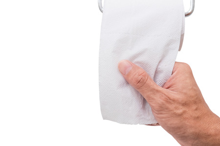 Isolated hand pulling toilet paper from roll