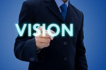 Businessman in dark gray suit pointing his finger out to vision. Vision of leader is very important in global business.の写真素材