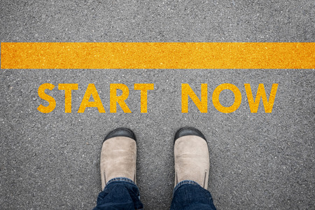 Brown suede shoes standing on the asphalt concrete floor at START NOW line.の写真素材