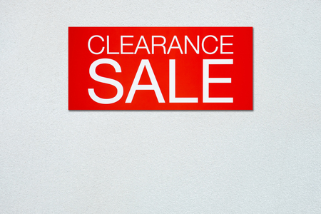 Red clearance sale billboard on white concrete wallの写真素材