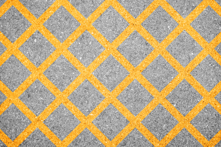 Yellow criss cross line on the street representing no parking areaの写真素材