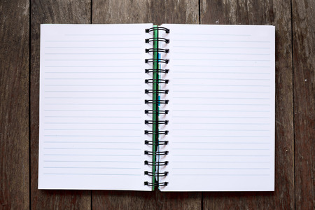 Opened business organizer notebook on wooden tableの写真素材