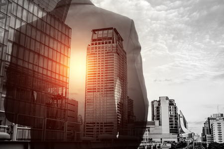 Double exposure of businessman in suit and Bangkok city cityscape. He's looking for his success in business and idea for lifeのeditorial素材