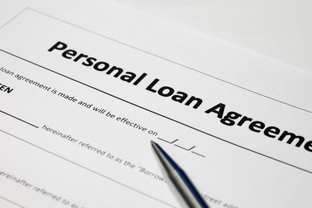 Personal loan agreement form document and stainless steel penの写真素材