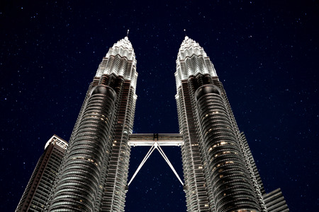 Petronas twin towers in Kuala Lumpur city, Capital of Malaysia at night and the stars shining in the...