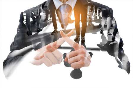 Double exposure businessman cross his fingers and people walking. Representing wrong, not correct, not allow, fault; no violence, no mob, no protest.の写真素材