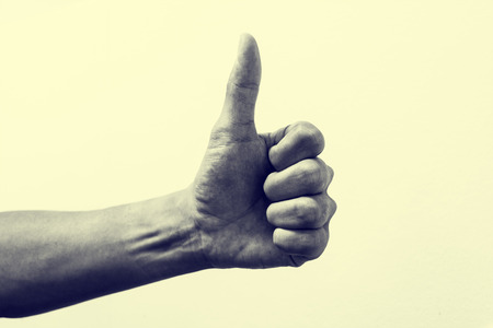Isolated thumb up representing good and positive conceptual communication. Vintage effectの写真素材