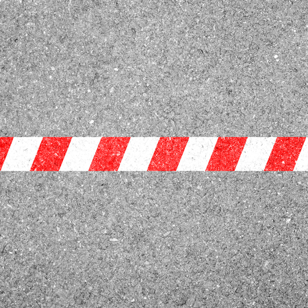 Red white line on the road representing it's limit, end and not allowed to cross.