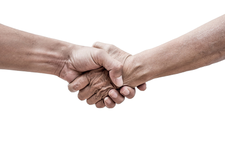 Dramatic help hands holding together representing friendship, partnership, help and hope, donation, assistance. Helping old, poor and hunger.の写真素材