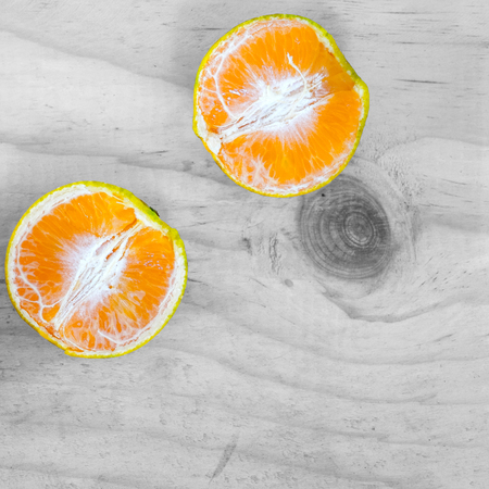 Flat lay Thai fruits on monotone wooden table - Tangerine oranges.の写真素材