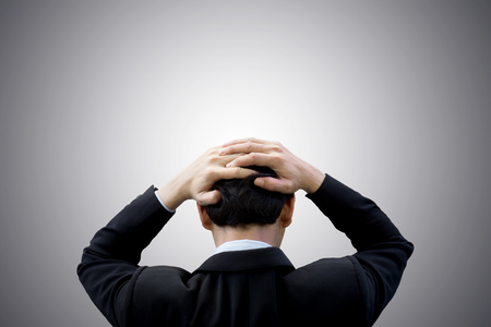 Businessman feeling headache and confuse in work and business.の写真素材