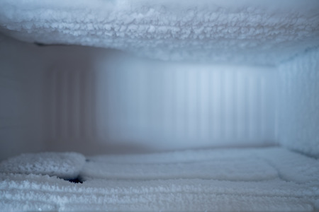 Empty freezing compartment in refrigerator full of ice.の写真素材