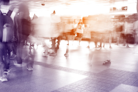 Moving blur people walking in railway station - black and white effect