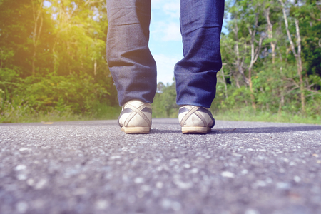One standing on the road. Concept of start, begin, travel, freedom, decision making.の写真素材