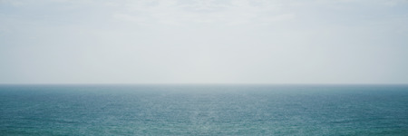 Deep blue seascape panorama with bright sky at horizon for background.の写真素材