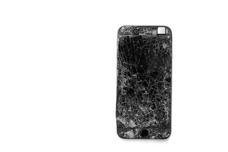 Isolated broken smartphone on white background.の写真素材