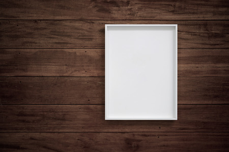 Empty white frame on wooden wall for interior decoration. Minimal concept.