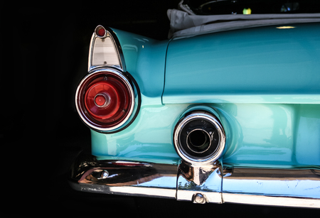 Chrome rear tail lights, bumper and exhaust of convertable turquoise vintage car.のeditorial素材