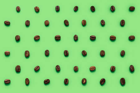 Lots of coffee beans stacked in rows. Pattern in a minimalistic style. Isolated on backgroundの写真素材