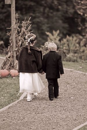 flowergirl and ringbearer boy and girl walking away togetherの写真素材