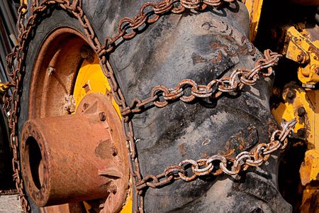 rusty chain on a big tractor wheelの写真素材