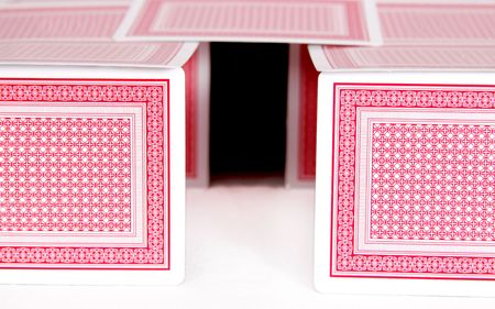 flimsy cardhouse of playing cards showing real estate and housing projectsのeditorial素材