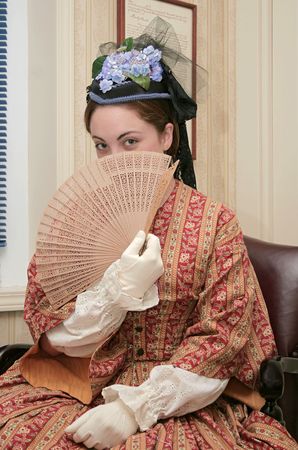 young woman with a fan dressed in 1860s style clothing young woman with a fan dressed in 1860s style clothing