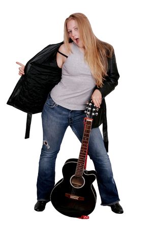 young woman in a black leather jacket and blue jeans with a guitar over whiteの写真素材