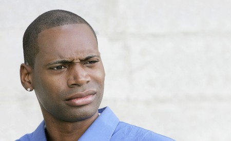 one disgusted looking shocked or surprised African American guy closeup portrait outdoorsの写真素材
