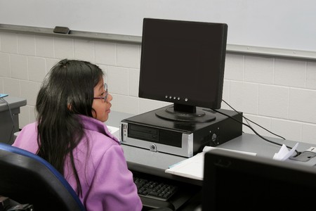 one young student girl studying on the computer in school