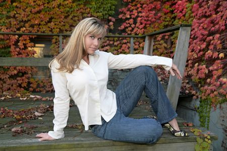 one young twenties woman outdoors sitting and smilingの写真素材