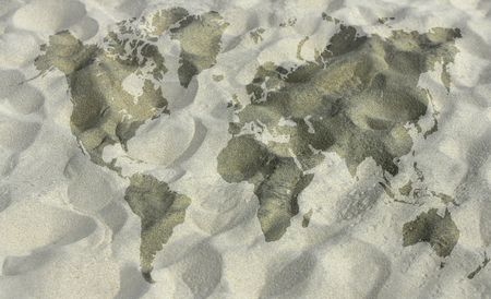 textured map of the Earth land masses in wet sand on the beachの写真素材