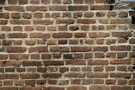 dark brown brick wall with opening top right
