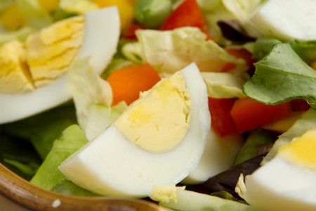 large colorful salad with egg, lettuce, peppers and moreの写真素材
