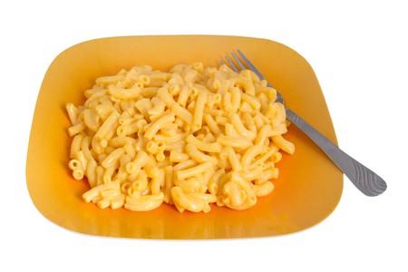 macaroni and cheese dinner on a yellow plate isolated over whiteの写真素材