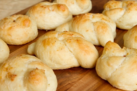 many garlic knots on a wooden cutting boardの写真素材