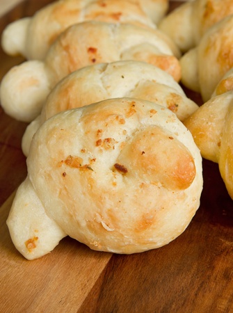 many garlic knots on a wooden cutting boardの写真素材