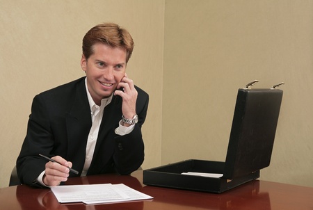 business man working with papers and briefcaseの写真素材