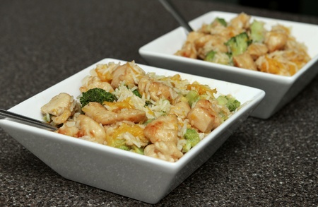 close up bowl of ginger orange chicken with broccoli and soy sauceの写真素材