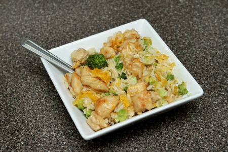 close up bowl of ginger orange chicken with broccoli and soy sauceの写真素材
