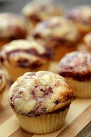 white chocolate and raspberry flavored muffin on a cutting boardの写真素材