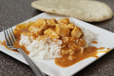 one serving of a spicy chicken tikka marsala over basmati riceの写真素材