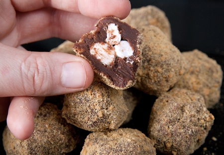 chocolate and marshmallow smores truffles closeup with one cut openの写真素材