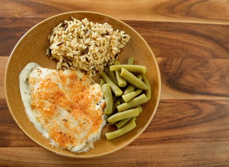 tilapia and parmesan sauce with rice and green beans mealの写真素材